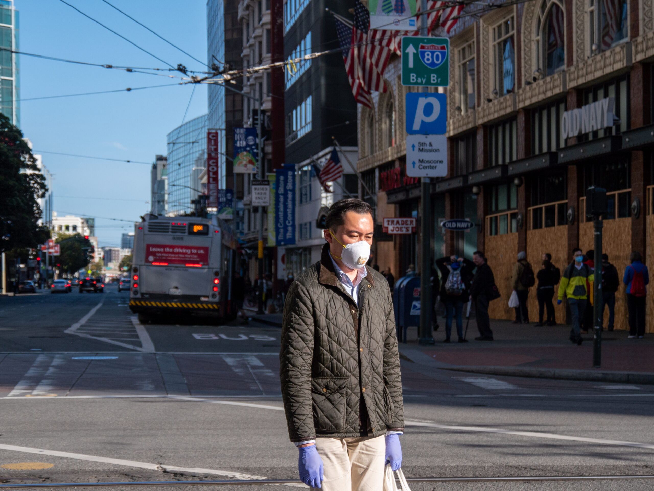 A man crosses Market Street in San Francisco last April during the pandemic. Photo by Philip Wyers / iStock
